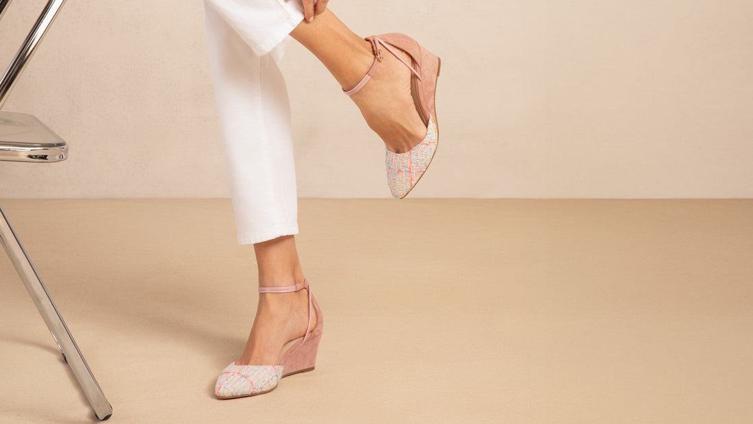 Landmark Petal pink tweed-toe wedges worn with white trousers, one foot raised