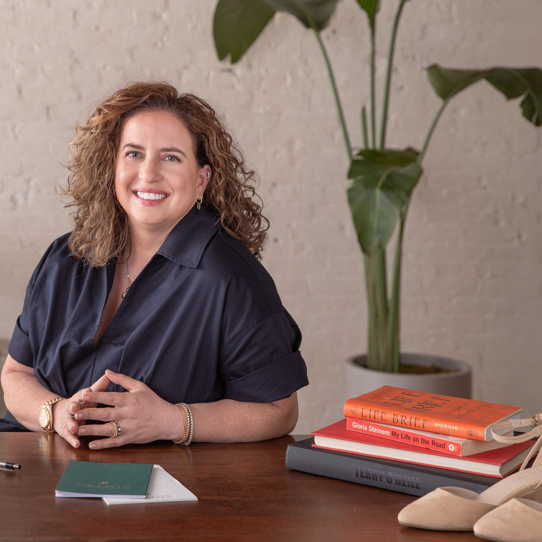 Dr. Steffie Tomson, founder of Steffie's, at her desk with Landmark Safari and Lava wedges