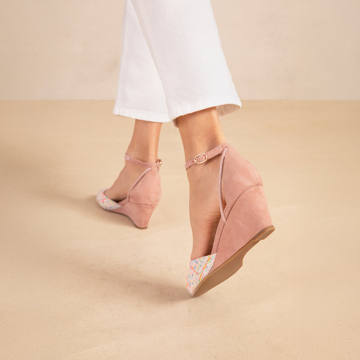 A woman's foot in a pink wedge heel 